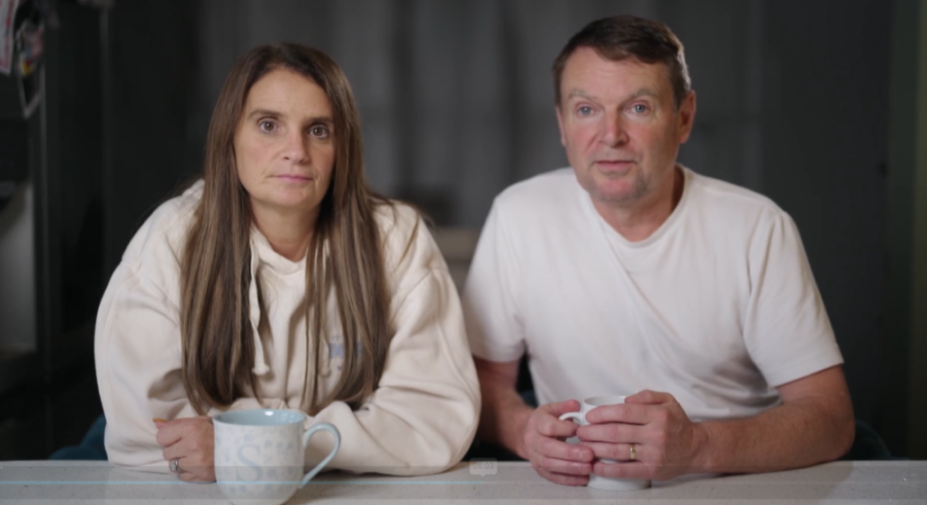 Sue and Noel Radford seated at a table with mugs.