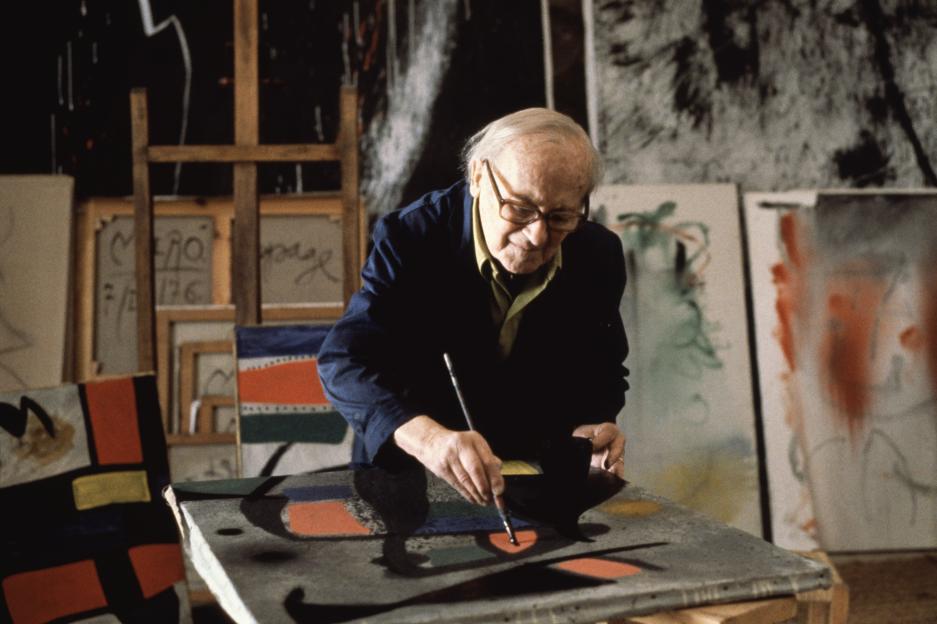 Surrealist painter Joan Miró painting in his workshop.