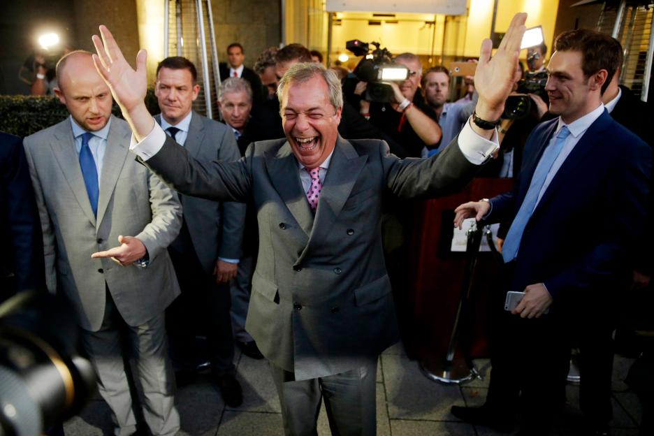 Nigel Farage, leader of the UK Independence Party, celebrating and posing for photographers.