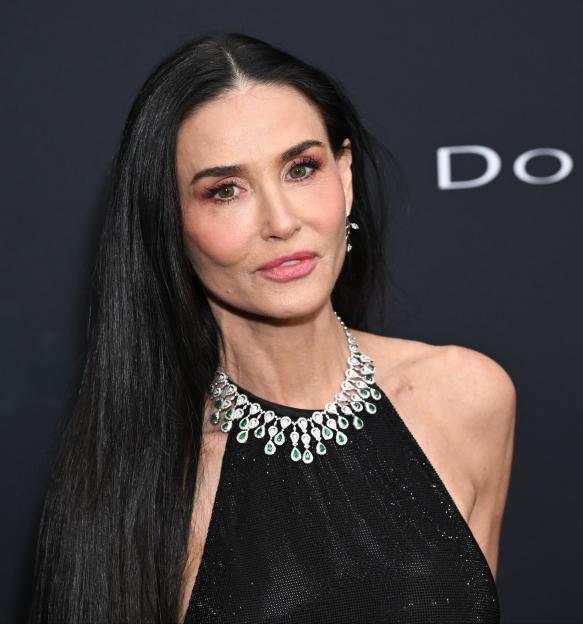 Demi Moore attends the 2026 WWD Style Awards in a black dress and emerald necklace.