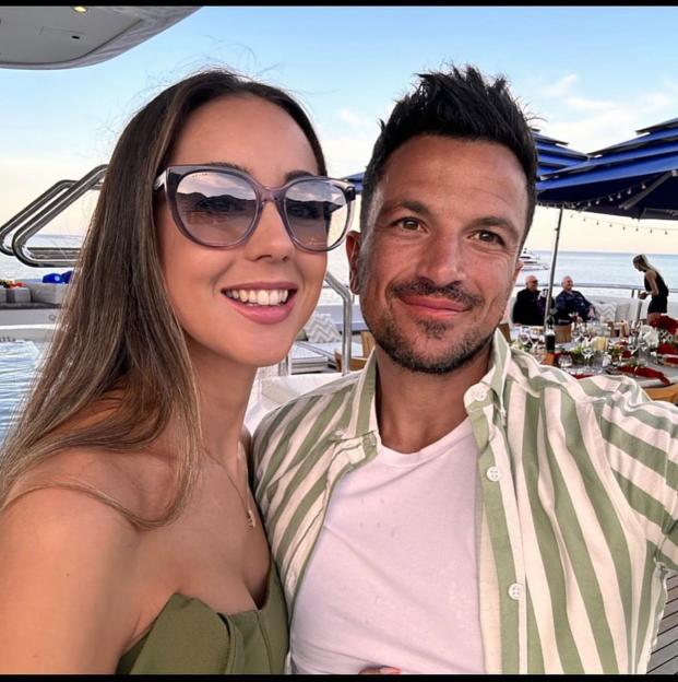 Peter and Emily Andre pose for a selfie on a boat.