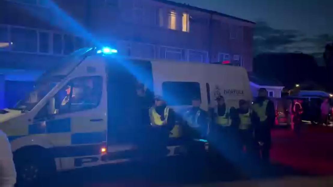 Police escorting migrants to safety in Thetford.