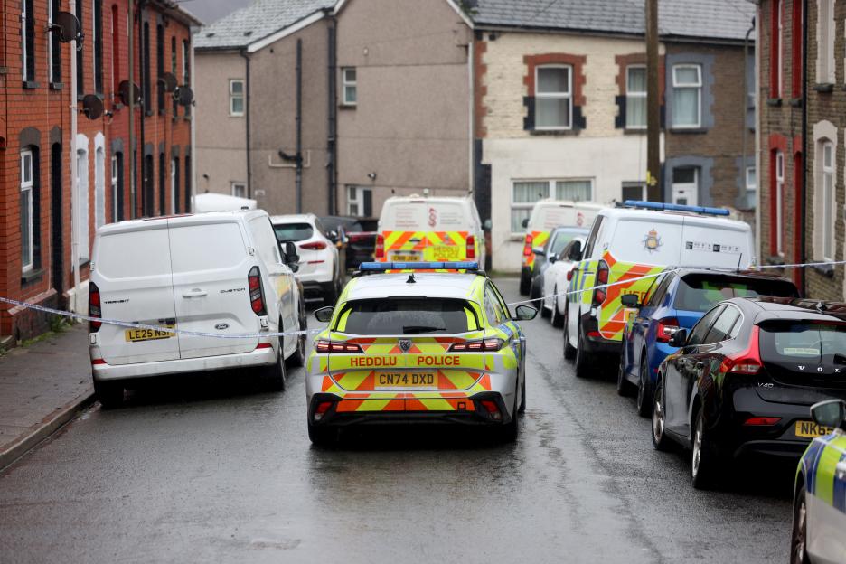 Police vehicles and vans at Lower Francis Street, Abertridwr, investigating an incident.