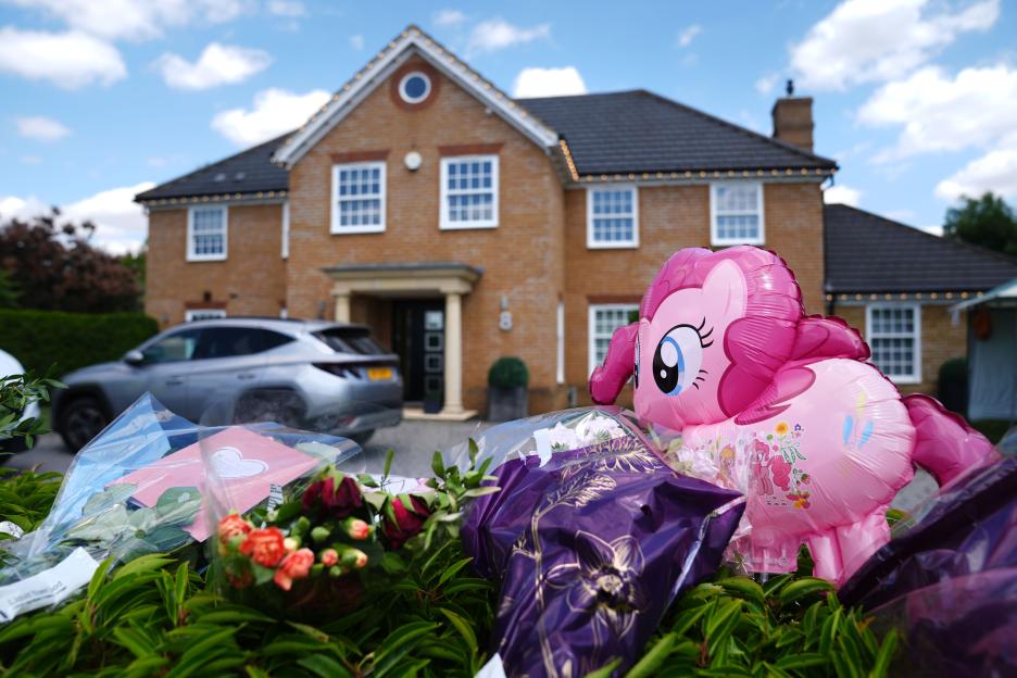 Flowers and a pink My Little Pony balloon left outside a house on Carnoustie Drive, Great Denham.