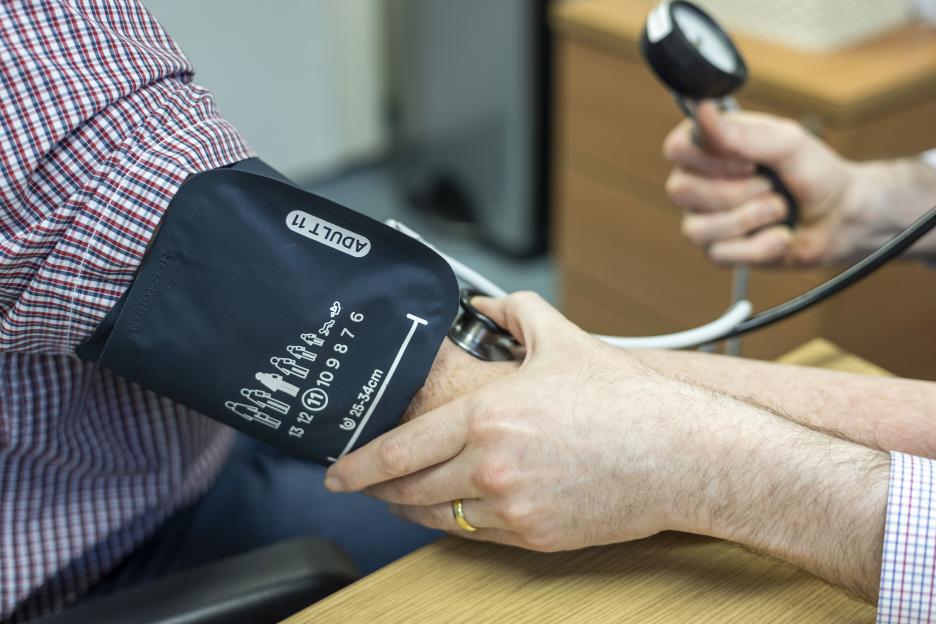 A doctor taking a patient's blood pressure.