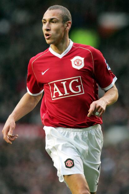 Manchester United player Mikaël Silvestre in his red jersey and white shorts.