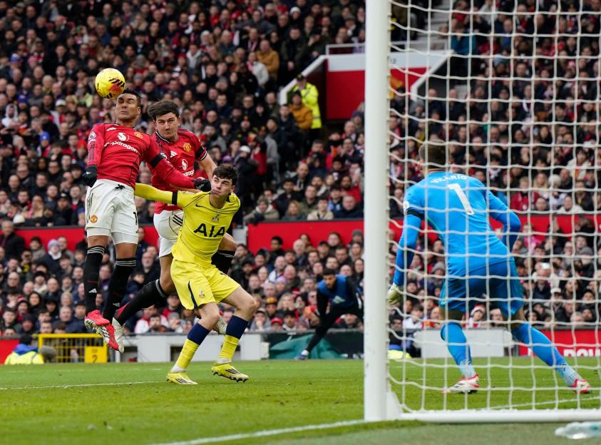 Manchester, England, 7th February 2026. Casemiro of Manchester United and Harry Maguire of Manchester United both go for the same ball during the Manchester United vs Tottenham Hotspur Premier League match at Old Trafford, Manchester. Picture credit