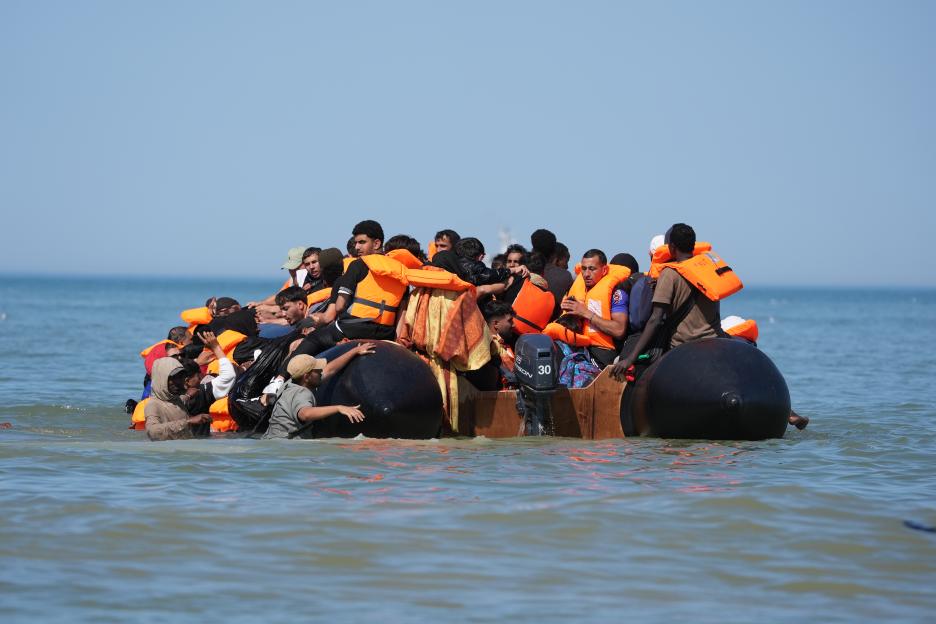 People thought to be migrants attempt to board a small boat off the coast of Hardelot, France.