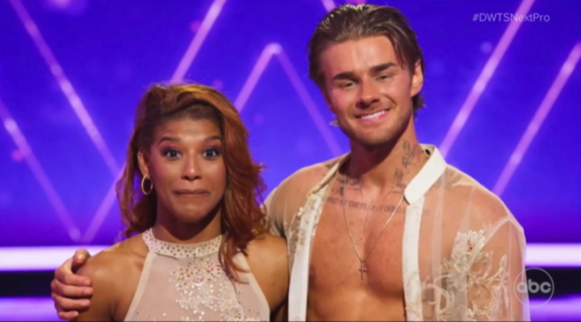 A man and woman standing next to each other on a stage.