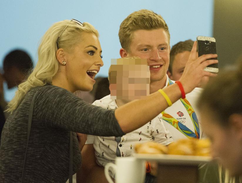 Adam Peaty Is Welcomed Home From Rio By His Friends And Family. Adam Peaty Smiles For A Selfie As He Is Reunited With His Sister Bethany And Her Son. Team Gb Are Welcomed Home From Rio Olympics At Heathrow Terminal 5. The Nose Of The Plane Is Painted