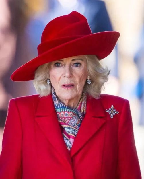 Queen Camilla in a red coat and matching hat attending the Christmas Morning Service.