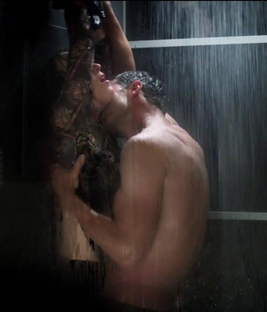 Jamie Dornan and Dakota Johnson in a passionate embrace in the shower.