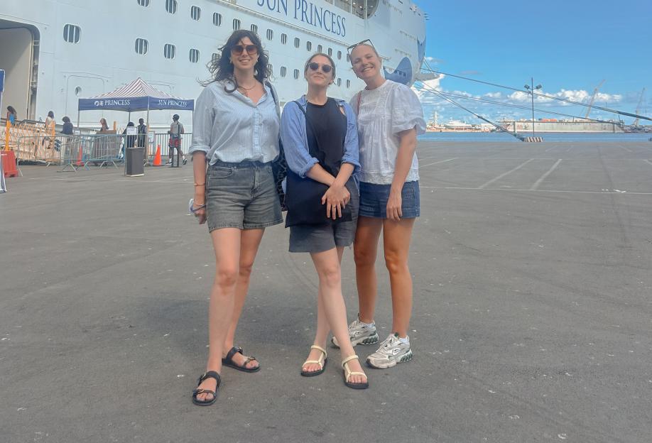 Three women posing in front of the Sun Princess cruise ship.