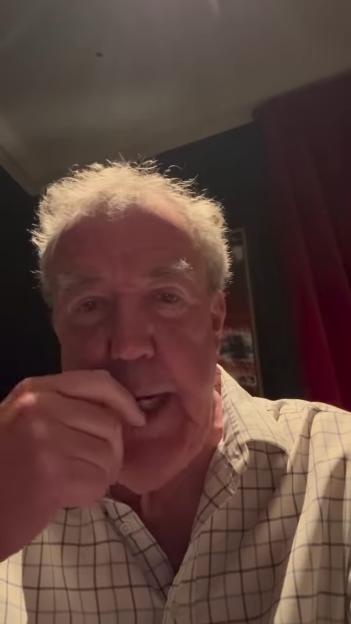 Jeremy Clarkson chewing, with a hand to his mouth.