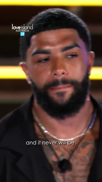 A contestant on Love Island Australia looks at the camera with a serious expression.