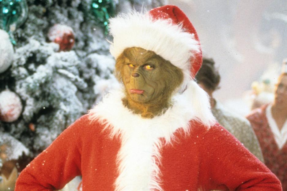 The Grinch wearing a Santa suit from the film *How the Grinch Stole Christmas*.