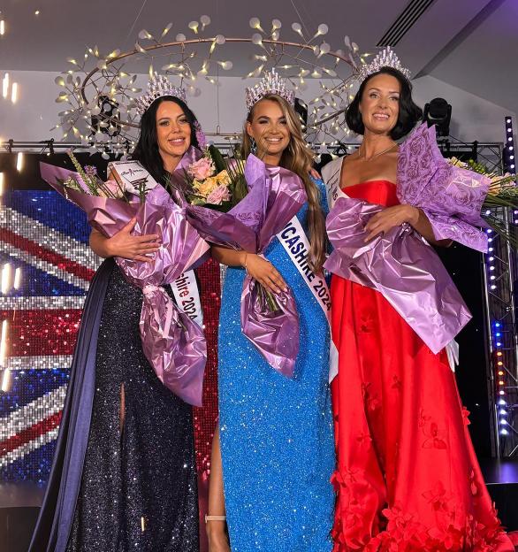 Three pageant winners in gowns and tiaras, holding bouquets of flowers.