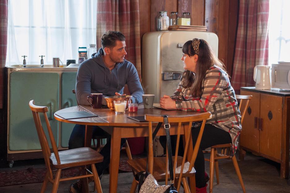 Fabrizio Santino and Jessica Ellis sitting at a wooden table.
