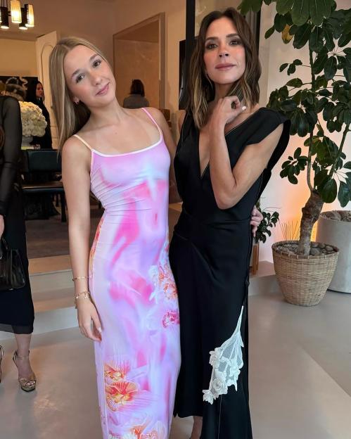 Victoria Beckham posing with Harper Beckham.