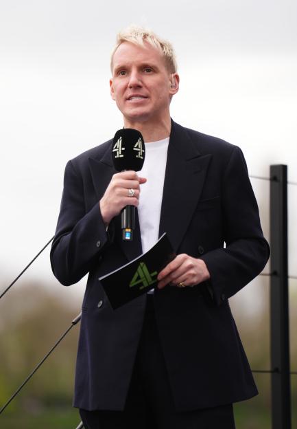 Jamie Laing, a Channel 4 presenter, holding a microphone and presentation notes.
