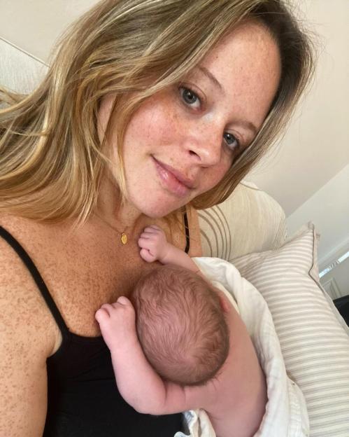 Emily Atack holding her baby boy.