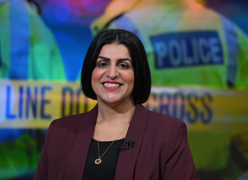 Home Secretary Shabana Mahmood smiling in a burgundy blazer.