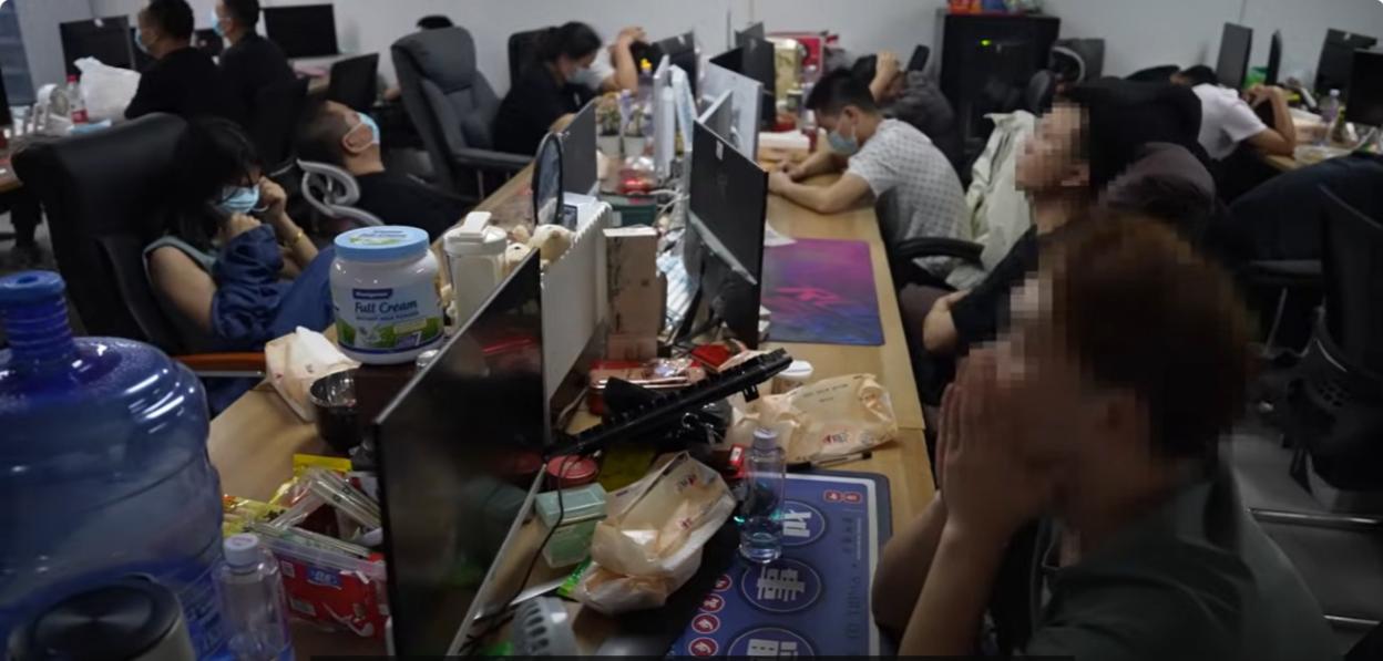 Trafficked workers packed into a crowded call center.