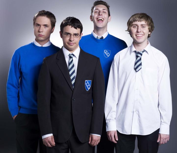 Four young men from The Inbetweeners series, Simon, Will, Neil, and Jay, dressed in school uniforms.