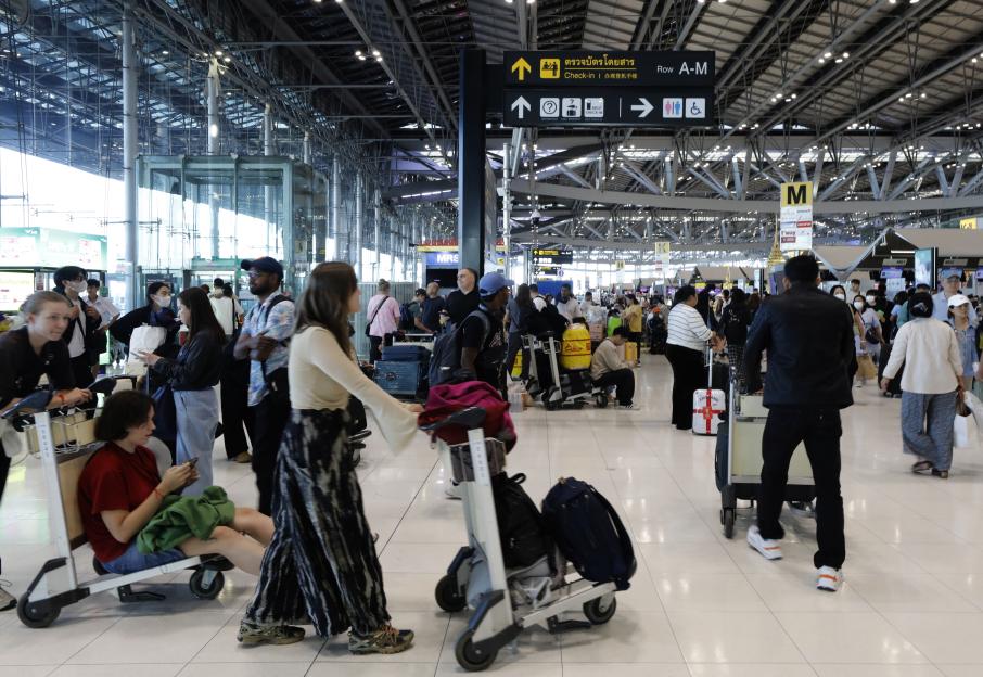 Passengers waiting inside Suvarnabhumi International Airport in Samut Prakan, Thailand, due to flight cancellations.