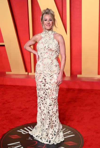 Ellie Goulding in a cream embroidered halter top gown with cutout sides.
