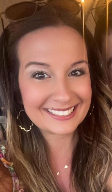 A woman smiling at the camera.