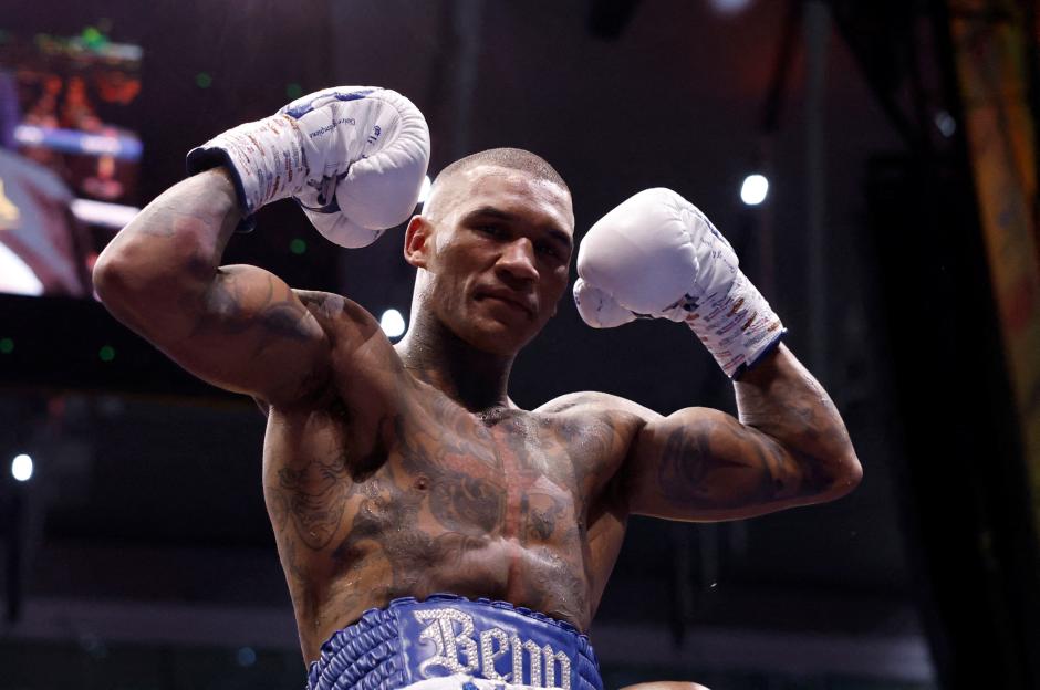 Conor Benn flexing his muscles and celebrating after winning the middleweight fight.
