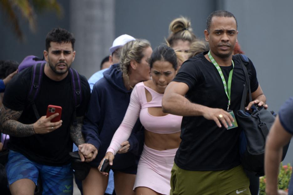 People evacuating a TV studio during an attack in Ecuador.