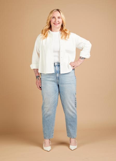 Annikki Sommerville wearing light wash jeans and a white button-down shirt.
