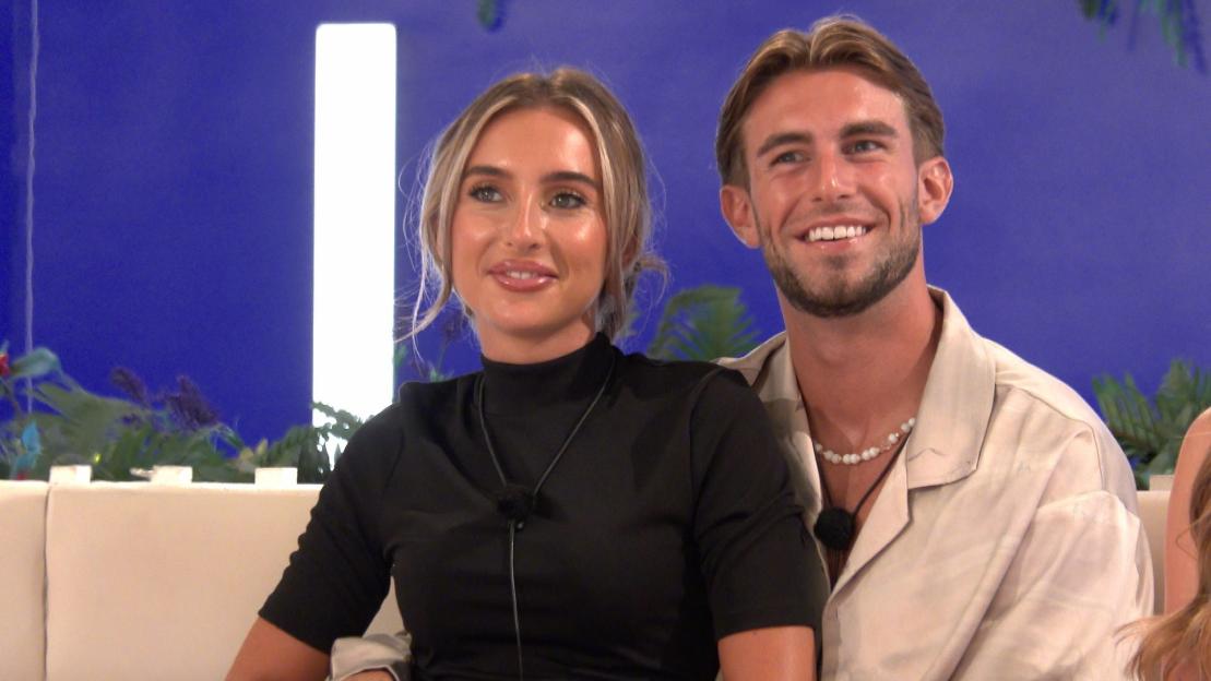Yasmin Hadlow and Tommy Murphy from "Love Island" sitting together.
