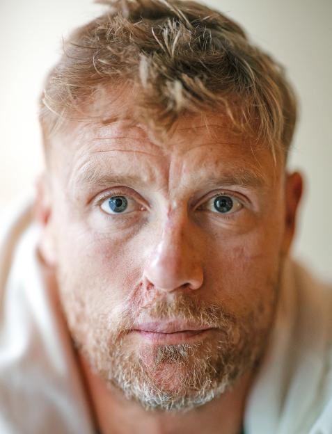 Andrew Flintoff, with a ginger beard, red hair, and blue eyes, looks directly at the camera.