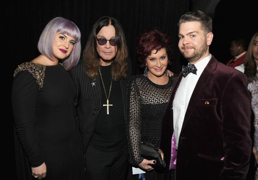 Jack Osbourne, Ozzy Osbourne, Kelly Osbourne, Sharon Osbourne, and Amy Osbourne seated at a table with food and drinks.