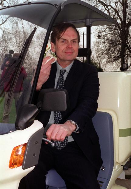 John Montagu, the 11th Earl of Sandwich, sitting in a special delivery motorbike and holding a sandwich.
