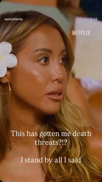 A woman with blonde hair and a flower behind her ear, on a Netflix show, says, "This has gotten me death threats?!? I stand by all I said."