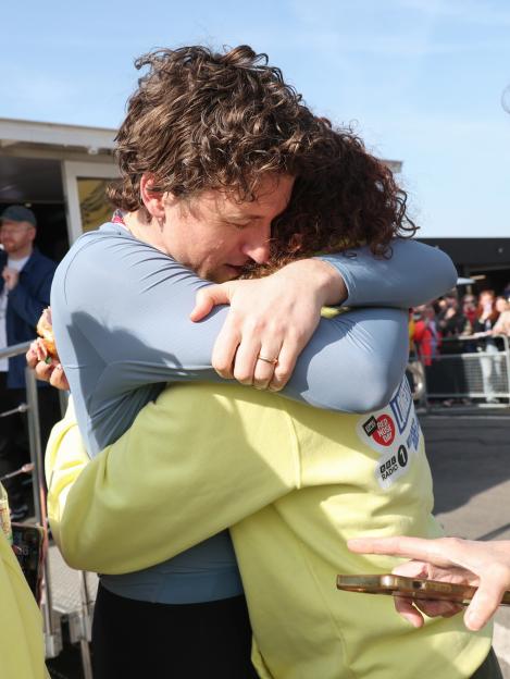 Greg James embracing a person after completing the Radio 1 Longest Ride challenge for Comic Relief.
