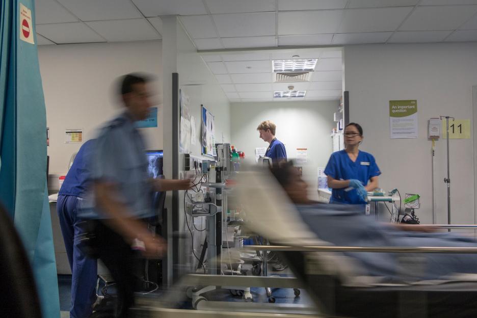 A busy hospital with doctors, nurses and staff busy at work in an accident and emergency ward in a British hospital
