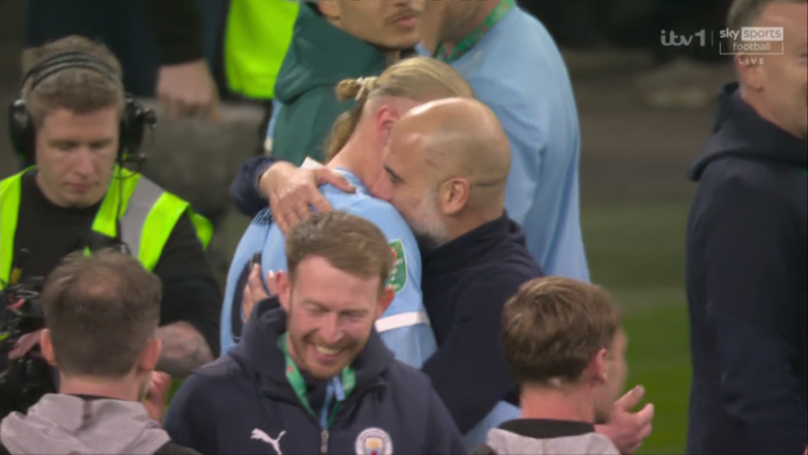 Pep Guardiola embracing a football player on the field.