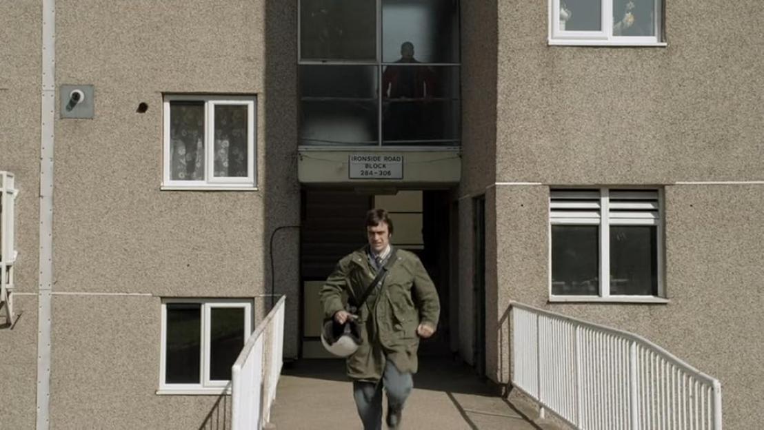 Shaun Fields from This is England exiting a block of flats.
