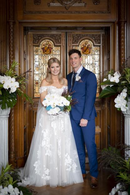 Olivia Frazer from Married at First Sight Australia in a wedding dress, standing with her groom.