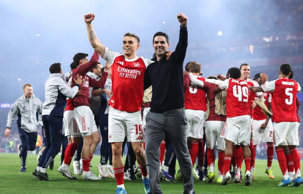 Mikel Arteta celebrating with Leandro Trossard and other Arsenal players after winning the UEFA Champions League Semi Final.