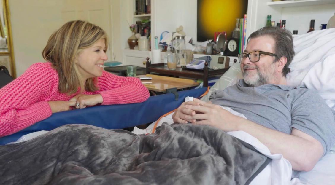 Kate Garraway and Derek Draper smiling at each other.