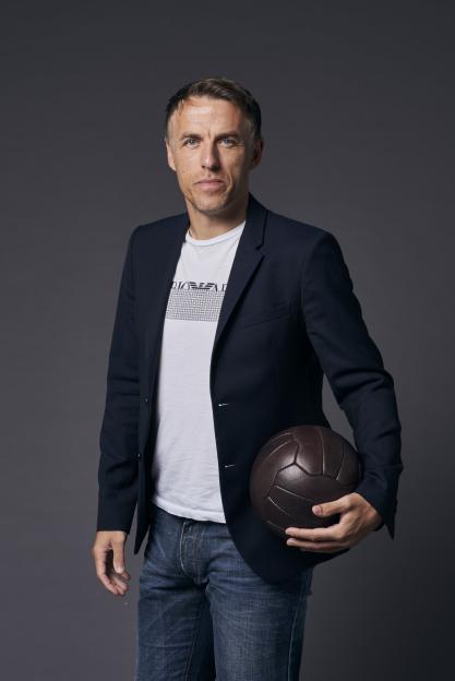 Gary Neville holding a vintage football.