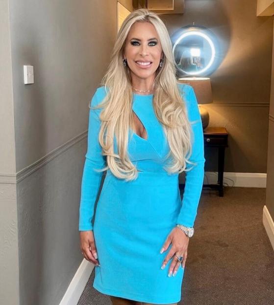 Rachel Lugo smiling in a blue dress with a cutout.