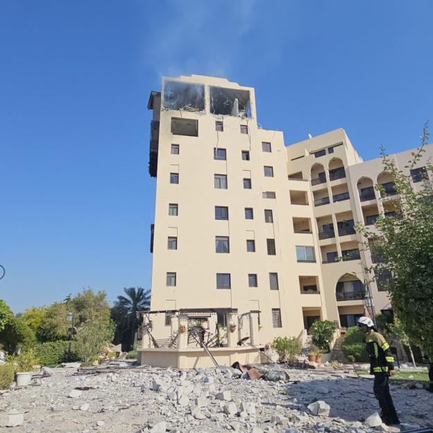 Smoke rises from a residential building, which according to the Bahraini Interior Ministry, was hit by an Iranian drone, in Muharraq