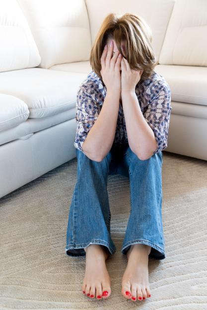 Woman in stress covered her face with her hands